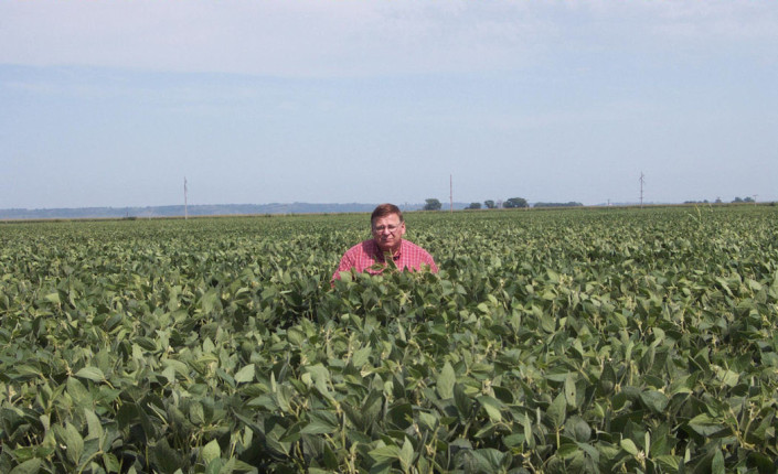 Salesman Gene standing in our soybean field. They yielded 100bu./A